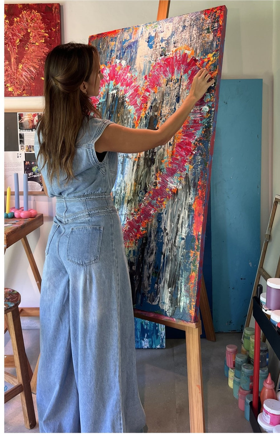 Tamy González pintando una obra de gran formato en su estudio